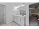 Bathroom with double sink vanity, white cabinets, and framed mirror at 229 Cramerton Mills Pkwy, Cramerton, NC 28032
