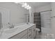 Well-lit bathroom features double sink vanity, framed mirror, and bathtub shower at 229 Cramerton Mills Pkwy, Cramerton, NC 28032