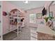 Pink bedroom featuring a bed lofted over a workspace with a desk and chair at 229 Cramerton Mills Pkwy, Cramerton, NC 28032