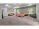 Spacious bedroom with decorative wall paneling, tray ceiling, and ample natural light at 229 Cramerton Mills Pkwy, Cramerton, NC 28032