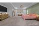 Large bedroom featuring decorative accent wall, tray ceilings and sitting area at 229 Cramerton Mills Pkwy, Cramerton, NC 28032