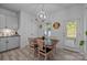 Cozy dining area with natural light, a wooden table, and an access door to the yard at 229 Cramerton Mills Pkwy, Cramerton, NC 28032