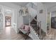 Bright foyer featuring a staircase, bench seating, and light wood flooring at 229 Cramerton Mills Pkwy, Cramerton, NC 28032
