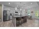 Modern kitchen features a granite island with bar seating and stainless steel appliances at 229 Cramerton Mills Pkwy, Cramerton, NC 28032