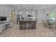 Modern kitchen featuring white cabinets, granite countertops, and a center island with seating at 229 Cramerton Mills Pkwy, Cramerton, NC 28032