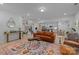 Open-concept living space flowing into a modern kitchen and staircase with light-filled areas at 229 Cramerton Mills Pkwy, Cramerton, NC 28032