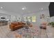 Spacious living room with ample seating, and an adjacent open-concept kitchen and dining area at 229 Cramerton Mills Pkwy, Cramerton, NC 28032