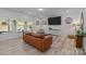 Bright living room with hardwood floors, stylish decor, and a comfortable seating area at 229 Cramerton Mills Pkwy, Cramerton, NC 28032