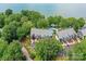 Aerial view of the building, pool, surrounding greenery, and lake at 303 Northwest Dr, Davidson, NC 28036