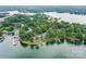 Aerial shot of building near lake featuring a dock and surrounding greenery at 303 Northwest Dr, Davidson, NC 28036