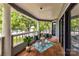 Balcony with cushioned chairs offers views of the surrounding trees, lake, and greenery at 303 Northwest Dr, Davidson, NC 28036