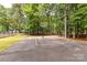 A well-maintained basketball court awaits friendly games and outdoor fun in a serene wooded setting at 303 Northwest Dr, Davidson, NC 28036