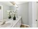 Bright bathroom featuring a double sink vanity, large mirror, and neutral wall color at 303 Northwest Dr, Davidson, NC 28036