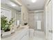 Clean bathroom featuring a glass-enclosed shower, white tile, and decorative plant at 303 Northwest Dr, Davidson, NC 28036