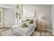 Bright bedroom with lake view features bedside tables with lamps and neutral linens and decor at 303 Northwest Dr, Davidson, NC 28036