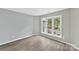 Bright bedroom boasts a large window offering great natural light and laminated wood flooring at 303 Northwest Dr, Davidson, NC 28036