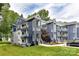 Modern condo exterior with blue siding, multiple balconies, and well-maintained landscaping at 303 Northwest Dr, Davidson, NC 28036