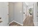 Bright hallway featuring wood-look floors, neutral walls, and a view into the living area at 303 Northwest Dr, Davidson, NC 28036