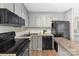 Efficient kitchen layout with granite countertops and sleek black appliances at 303 Northwest Dr, Davidson, NC 28036