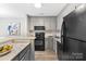 Kitchen with grey cabinetry, granite counters, and stainless steel appliances at 303 Northwest Dr, Davidson, NC 28036