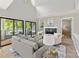 Living room with vaulted ceilings features glass doors leading to a balcony overlooking water views at 303 Northwest Dr, Davidson, NC 28036
