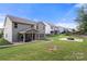 Expansive backyard with covered patio, fire pit area, and beautifully landscaped yard, ideal for entertaining at 3212 Gilroy Dr, Fort Mill, SC 29707