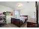 Bedroom features a charming sleigh bed, colorful wall decor, and a window with neighborhood views at 3212 Gilroy Dr, Fort Mill, SC 29707