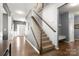 Hallway view featuring staircase and hardwood floors leads to the home's inviting living spaces at 3212 Gilroy Dr, Fort Mill, SC 29707