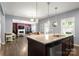 Kitchen featuring pendant lighting, a breakfast bar, and a view of the living room for seamless entertaining at 3212 Gilroy Dr, Fort Mill, SC 29707