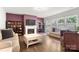 Cozy living room featuring a fireplace, built-in shelves, and large windows providing ample natural light at 3212 Gilroy Dr, Fort Mill, SC 29707