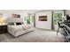 Bright main bedroom featuring a large bed, cityscape art, and dual windows for ample light at 3212 Gilroy Dr, Fort Mill, SC 29707