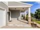 Covered porch with stone and column accents offers a charming welcome to this stylish home at 3212 Gilroy Dr, Fort Mill, SC 29707