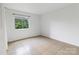 Bright bedroom with tile floor, closet, and view to exterior at 326 Orchard Trace Ln # 3, Charlotte, NC 28213