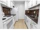 Galley kitchen features white cabinets, tile backsplash, and modern appliances at 326 Orchard Trace Ln # 3, Charlotte, NC 28213