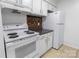 Kitchen with white appliances, cabinetry, and tile backsplash at 326 Orchard Trace Ln # 3, Charlotte, NC 28213