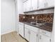 Kitchen area featuring tile backsplash, laminate countertops, and tile flooring at 326 Orchard Trace Ln # 3, Charlotte, NC 28213