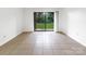 Bright living room with tile floors and sliding glass doors to the outside at 326 Orchard Trace Ln # 3, Charlotte, NC 28213