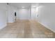 Spacious living room with tile flooring, closet, and view to the kitchen at 326 Orchard Trace Ln # 3, Charlotte, NC 28213