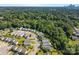 Neighborhood aerial view, capturing the layout of homes nestled within lush greenery and tree coverage at 3527 Crestridge Dr, Charlotte, NC 28217