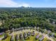 See homes and a skyline in this aerial of a neighborhood with mature trees and manicured lawns at 3527 Crestridge Dr, Charlotte, NC 28217