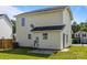 This is a view of the back of the house from the lawn, showcasing the siding and a small patio area at 3527 Crestridge Dr, Charlotte, NC 28217