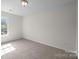 Empty bedroom offers neutral carpet, white trim, and natural light from a window at 3527 Crestridge Dr, Charlotte, NC 28217