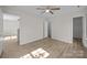 Spacious bedroom featuring wood-look floors, a ceiling fan, and natural light at 3527 Crestridge Dr, Charlotte, NC 28217