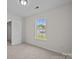 An empty bedroom features neutral carpet and a large window to exterior views at 3527 Crestridge Dr, Charlotte, NC 28217