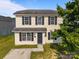 Inviting two-story home with light yellow siding, black shutters, and a classic design at 3527 Crestridge Dr, Charlotte, NC 28217