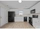 Modern kitchen with white cabinets, black appliances, and ample countertop space for cooking at 3527 Crestridge Dr, Charlotte, NC 28217