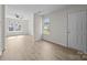 Neutral living space features hardwood floors, ample natural light, and a welcoming front door at 3527 Crestridge Dr, Charlotte, NC 28217