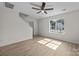 Bright living room with hardwood floors, a ceiling fan, and natural light streaming through the windows at 3527 Crestridge Dr, Charlotte, NC 28217