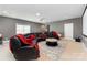 Finished basement with black leather couch, red throw pillows, projector and screen at 4005 Capullo Ct, Matthews, NC 28104