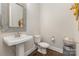 Charming half-bathroom with pedestal sink, wood floors, and decorative mirror at 4005 Capullo Ct, Matthews, NC 28104